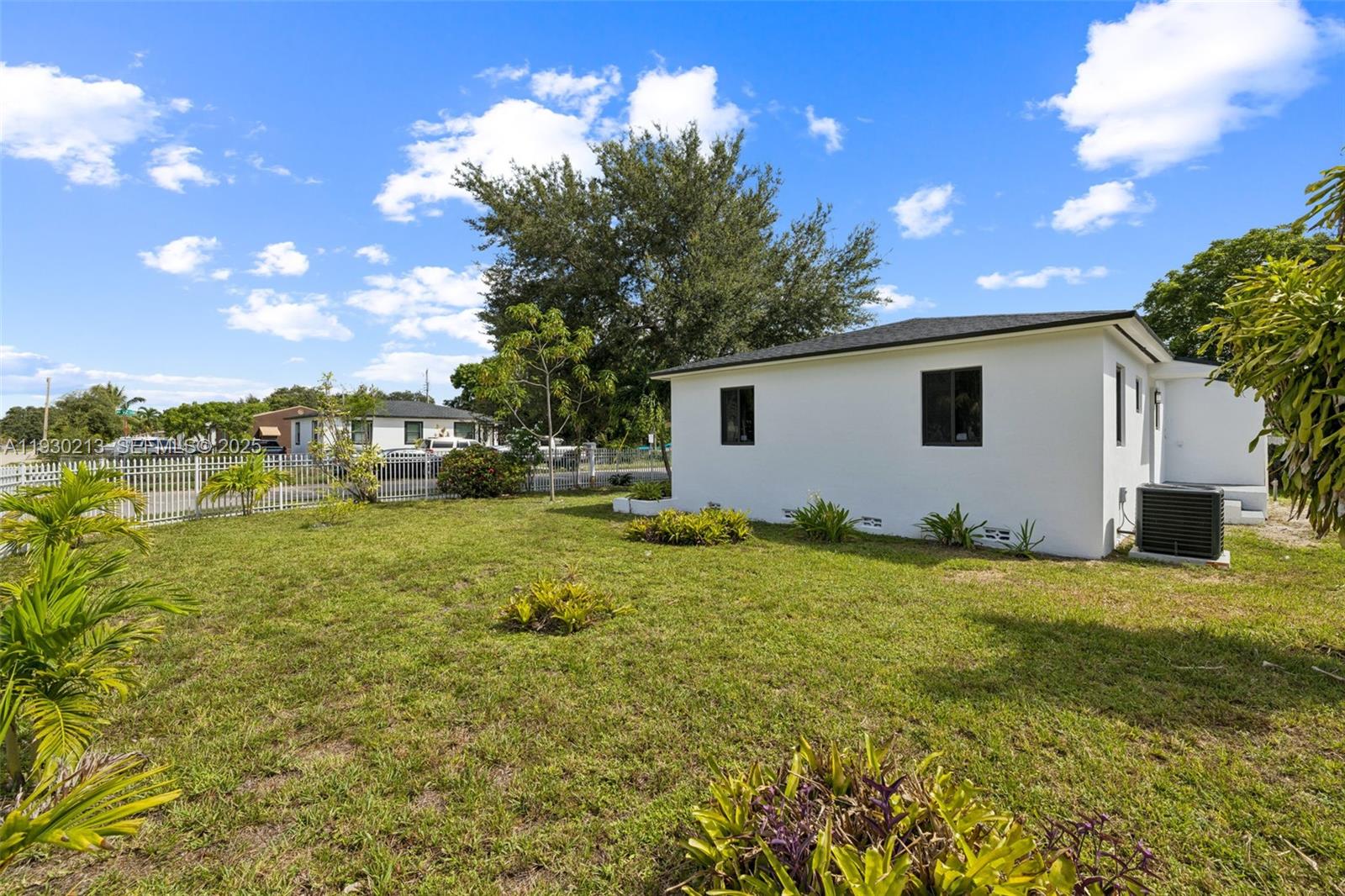 9055 Northwest 33rd Avenue Miami, FL 33147 - Photo 31 of 32 a view of a backyard with plants and large trees