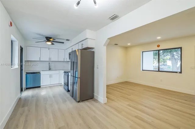 a view of kitchen with furniture and stainless steel appliances