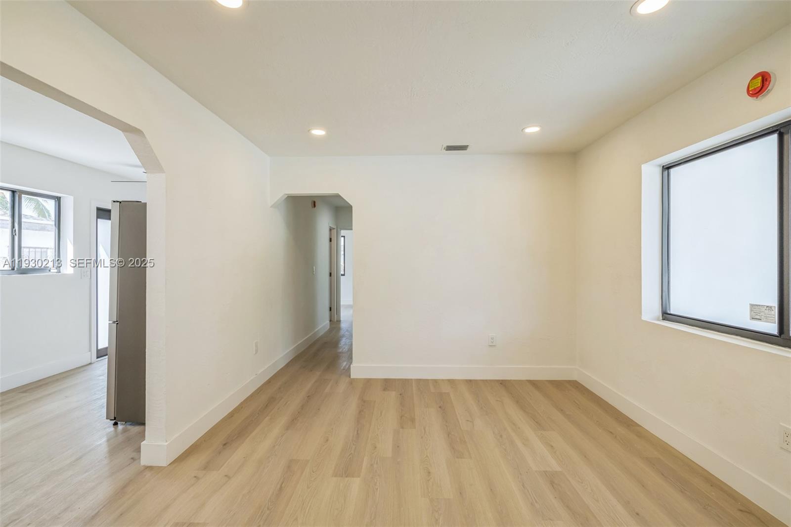 9055 Northwest 33rd Avenue Miami, FL 33147 - Photo 10 of 32 wooden floor in an empty room with a window