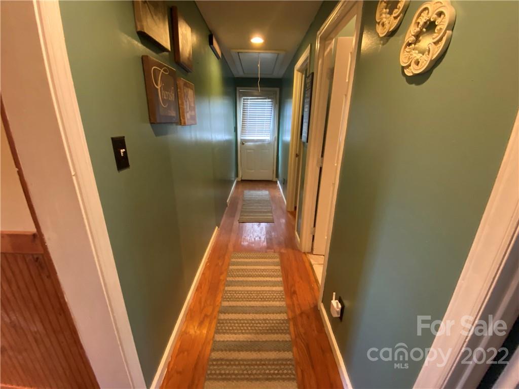 254 Landrum Road Tryon, NC 28782 - Photo 14 of 24 a view of a hallway with wooden floor and stairs