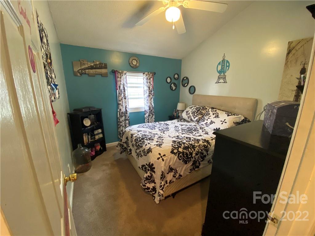 254 Landrum Road Tryon, NC 28782 - Photo 17 of 24 a bed sitting in a bedroom next to a window