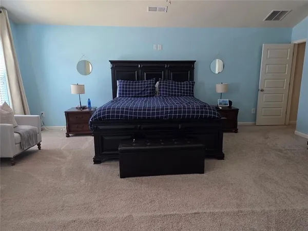 a bed sitting in a bedroom next to a window