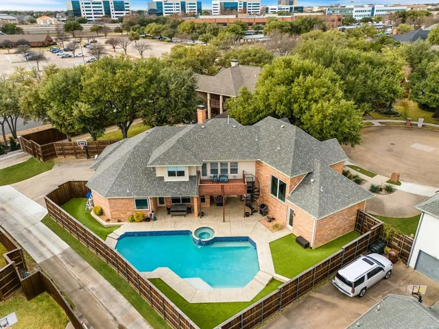 an aerial view of a house with swimming pool patio and outdoor seating