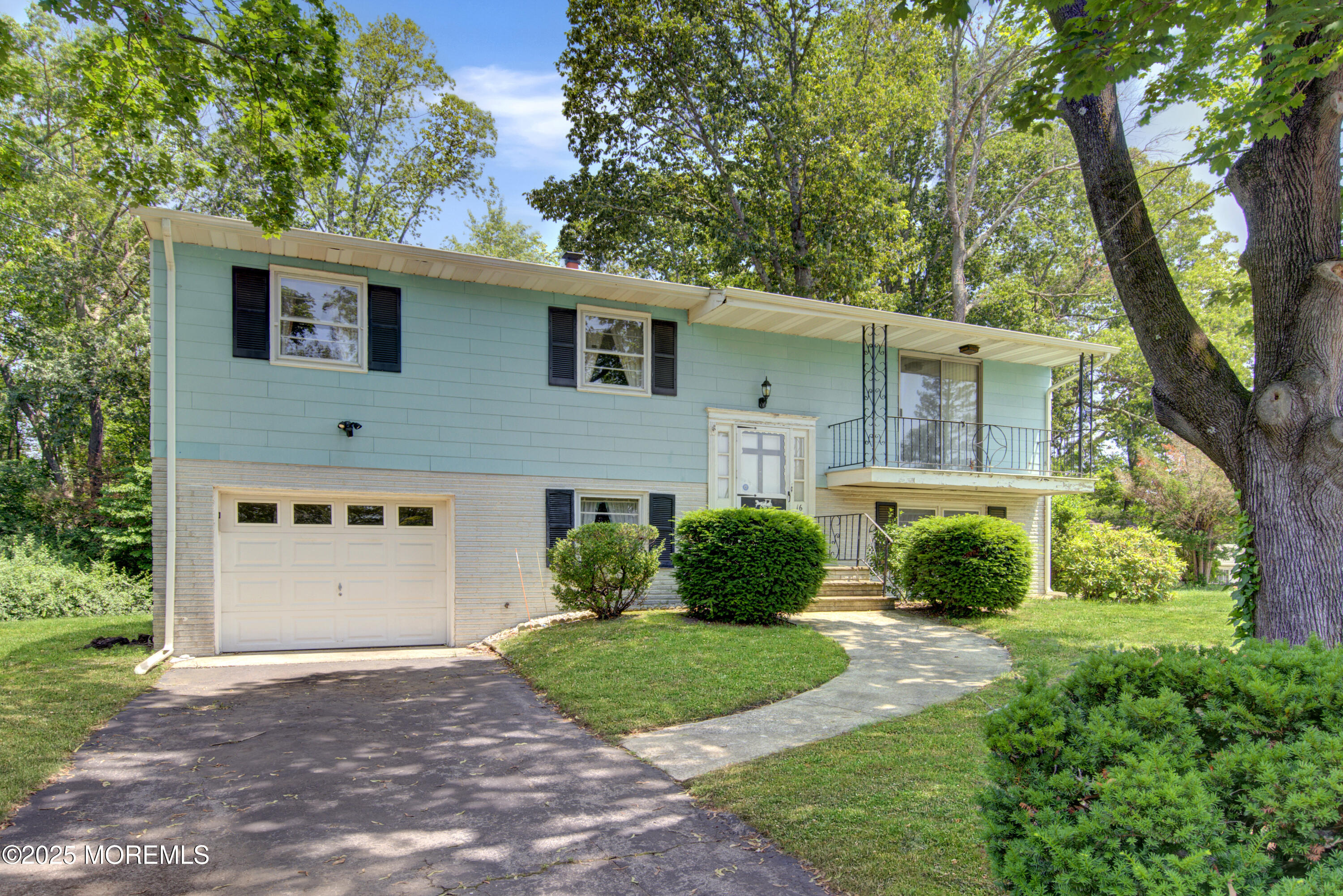 a front view of a house with a yard and trees