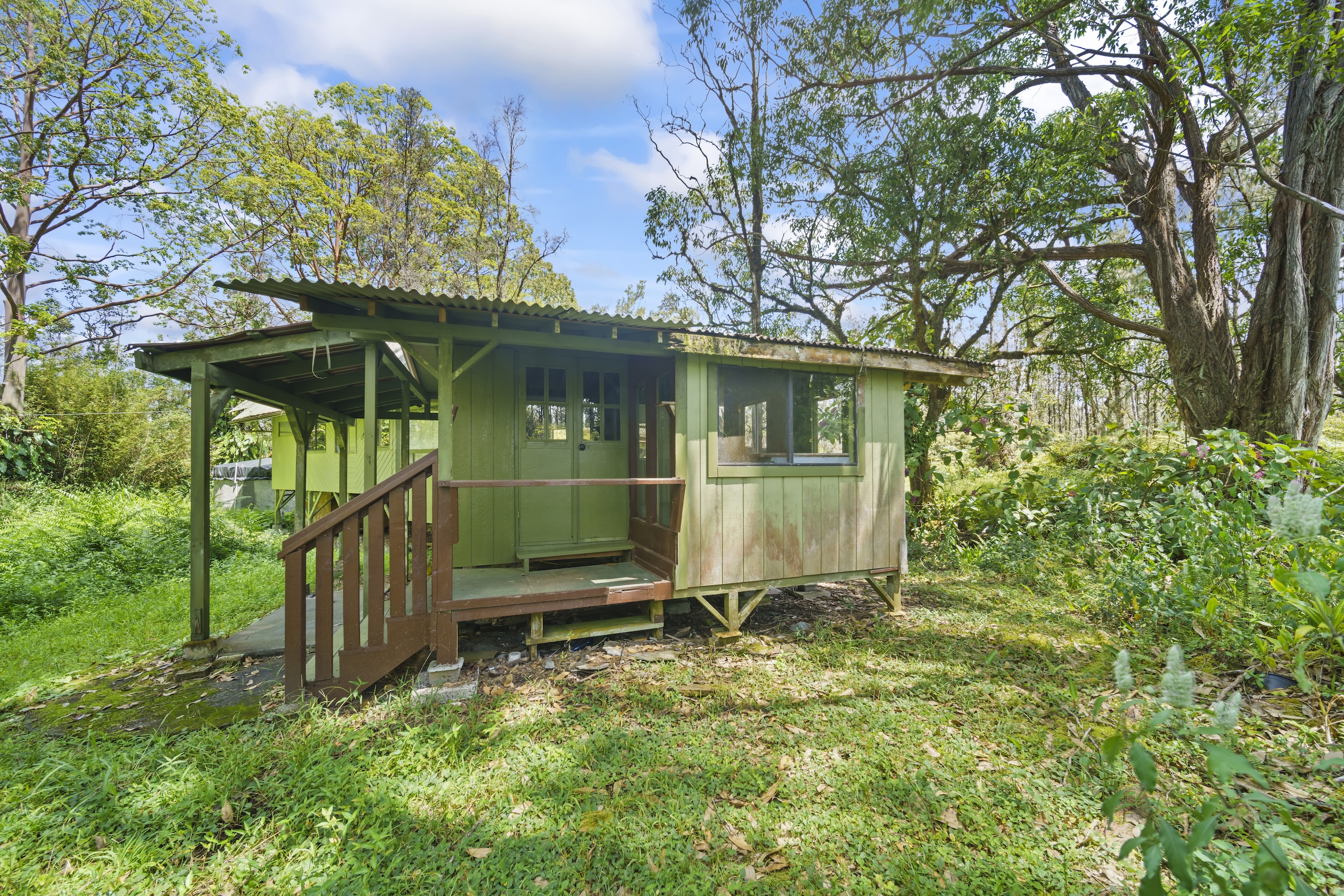 16-1857 Hopue Road Mountain View, HI 96771 - Photo 11 of 30 a view of a backyard with a small cabin