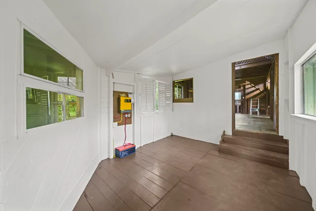 a view of an entryway with wooden floor and windows