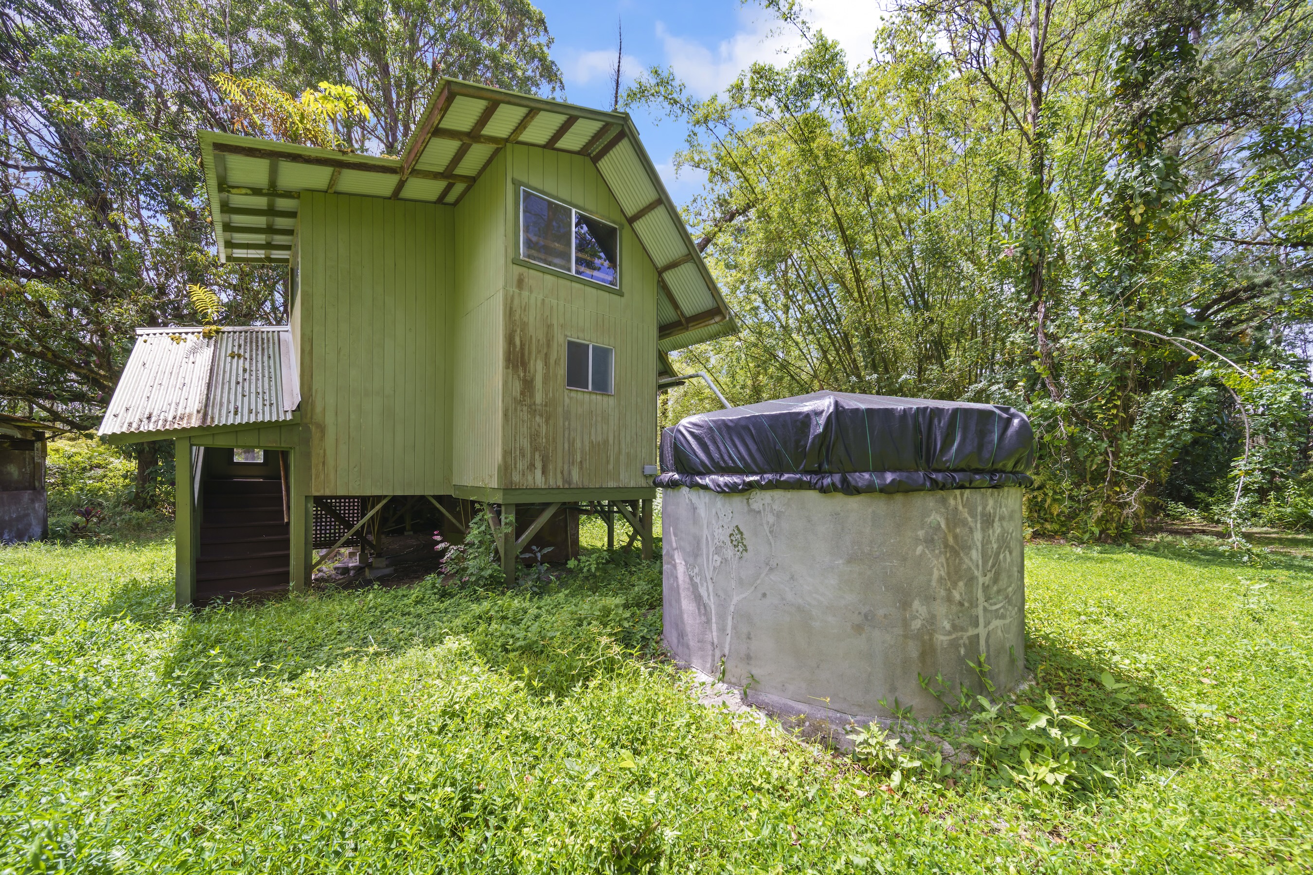 16-1857 Hopue Road Mountain View, HI 96771 - Photo 5 of 30 a house view with a garden