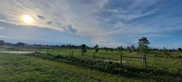 a view of a lake with a house in the background