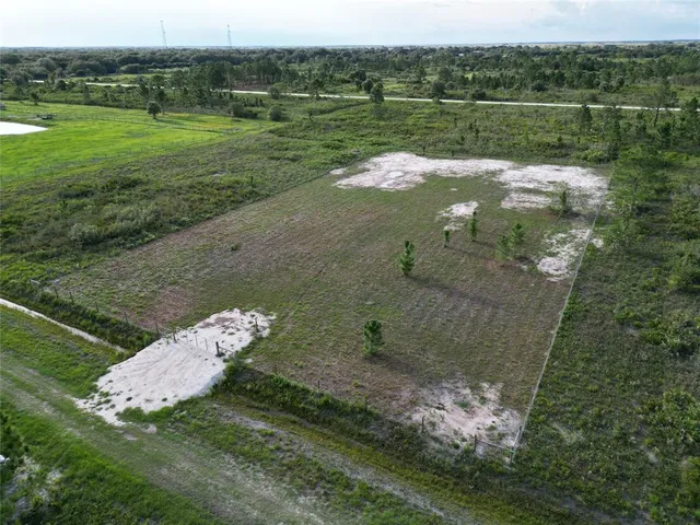 a view of a lake in middle of the green field