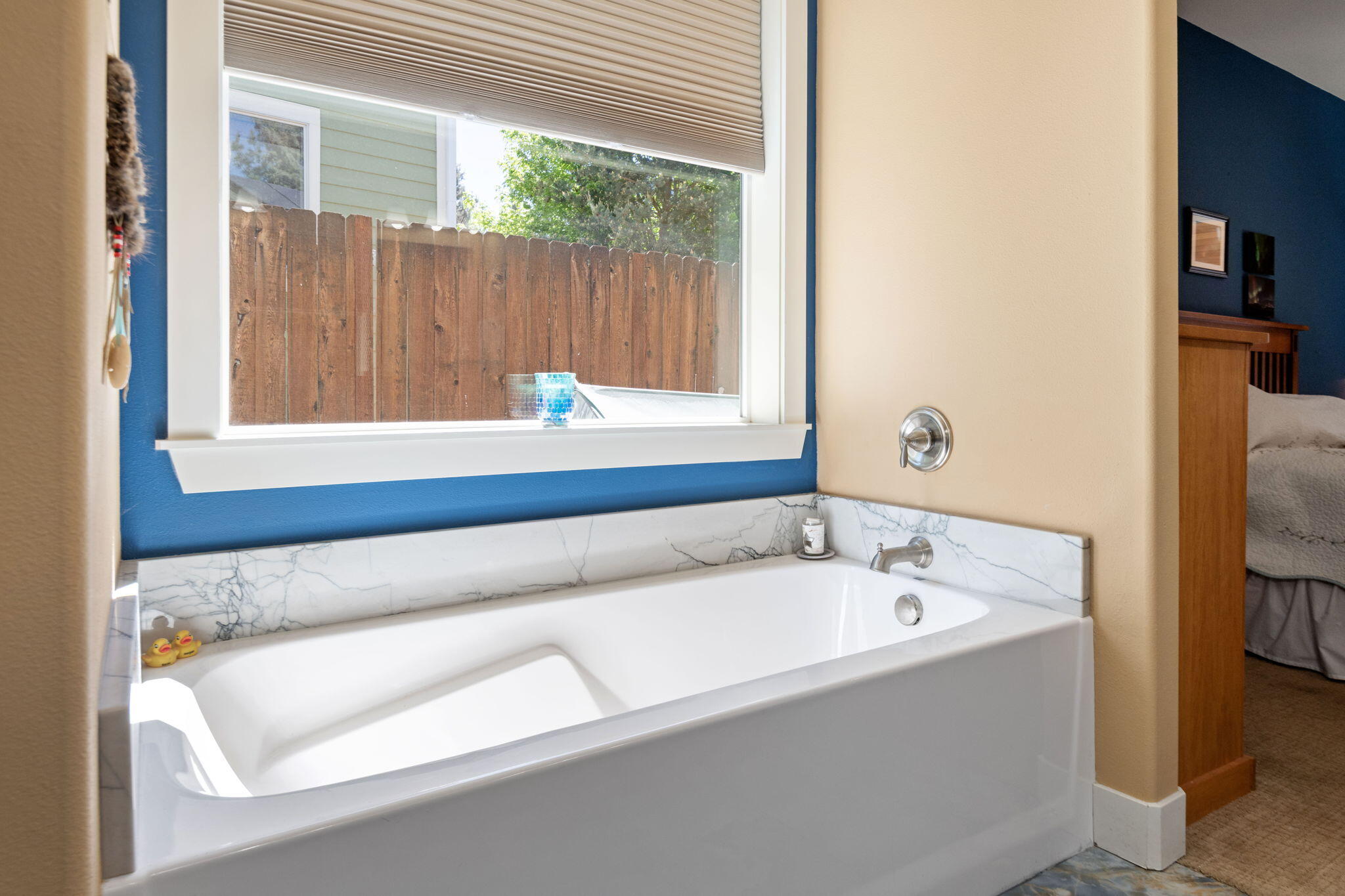 62944 Fresca Street Bend, OR 97703 - Photo 17 of 32 a bathroom with a bathtub and window
