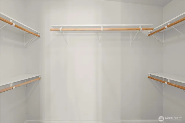 a bathroom with a double vanity sink mirror and shower