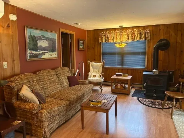 a view of a dining room with furniture and chandelier