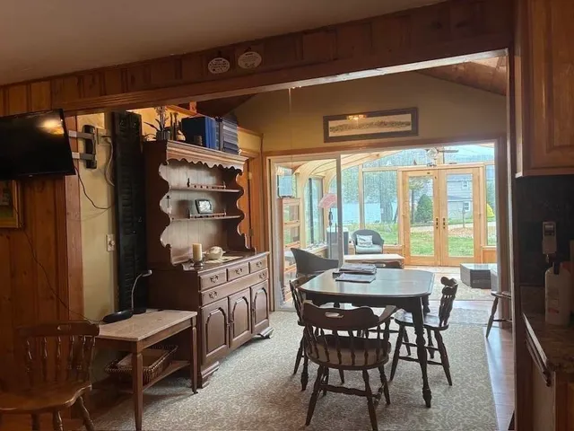 a living room with furniture and floor to ceiling windows