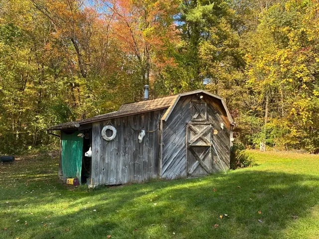 a backyard of a house with barbeque oven