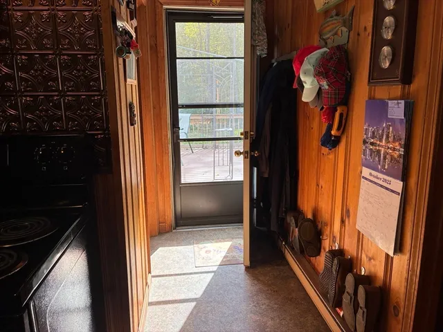 a kitchen with stainless steel appliances a refrigerator a stove a sink dishwasher and wooden cabinets with wooden floor