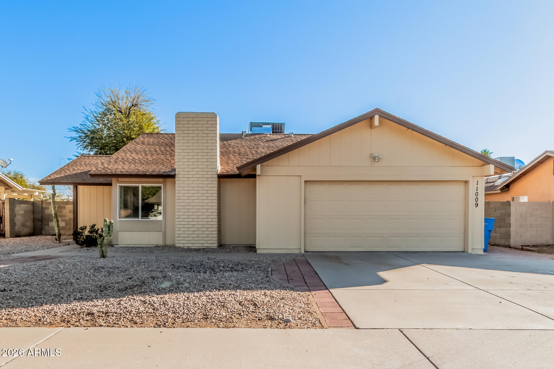 11009 South Tewa Street Phoenix, AZ 85044 - Photo 1 of 26 a front view of a house with a yard and garage