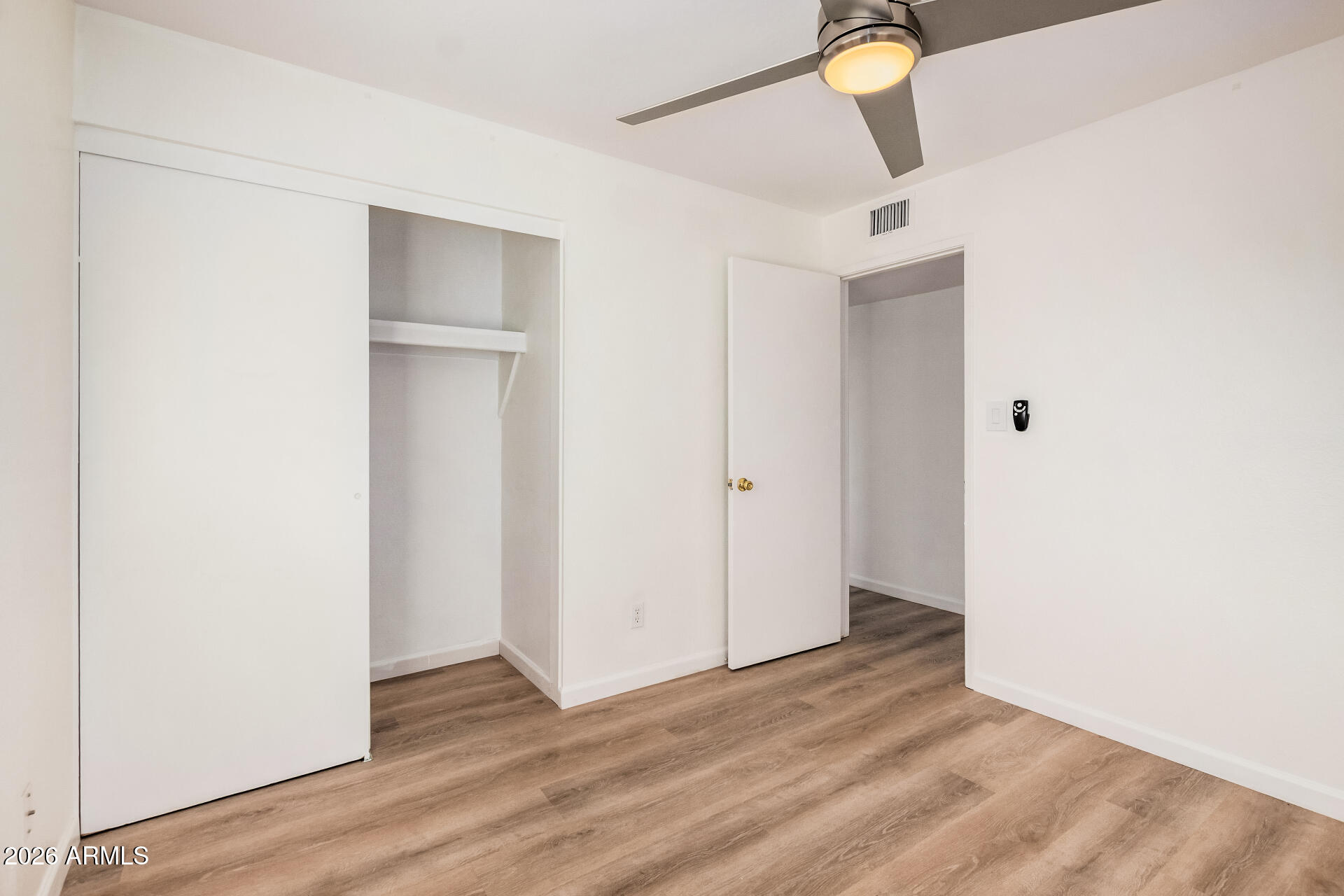 11009 South Tewa Street Phoenix, AZ 85044 - Photo 16 of 26 a view of empty room with wooden floor