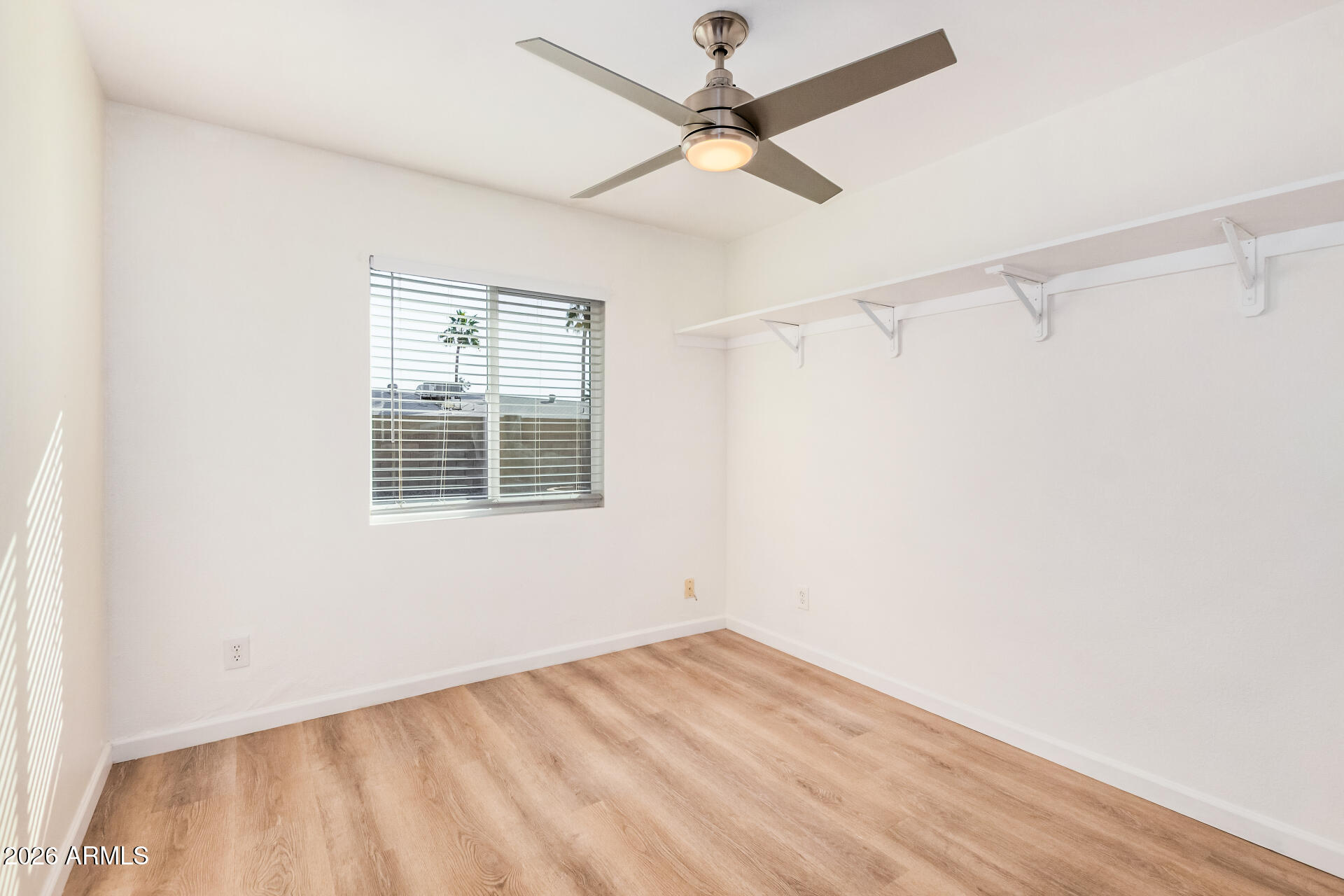 11009 South Tewa Street Phoenix, AZ 85044 - Photo 17 of 26 a view of an empty room with a window and a ceiling fan