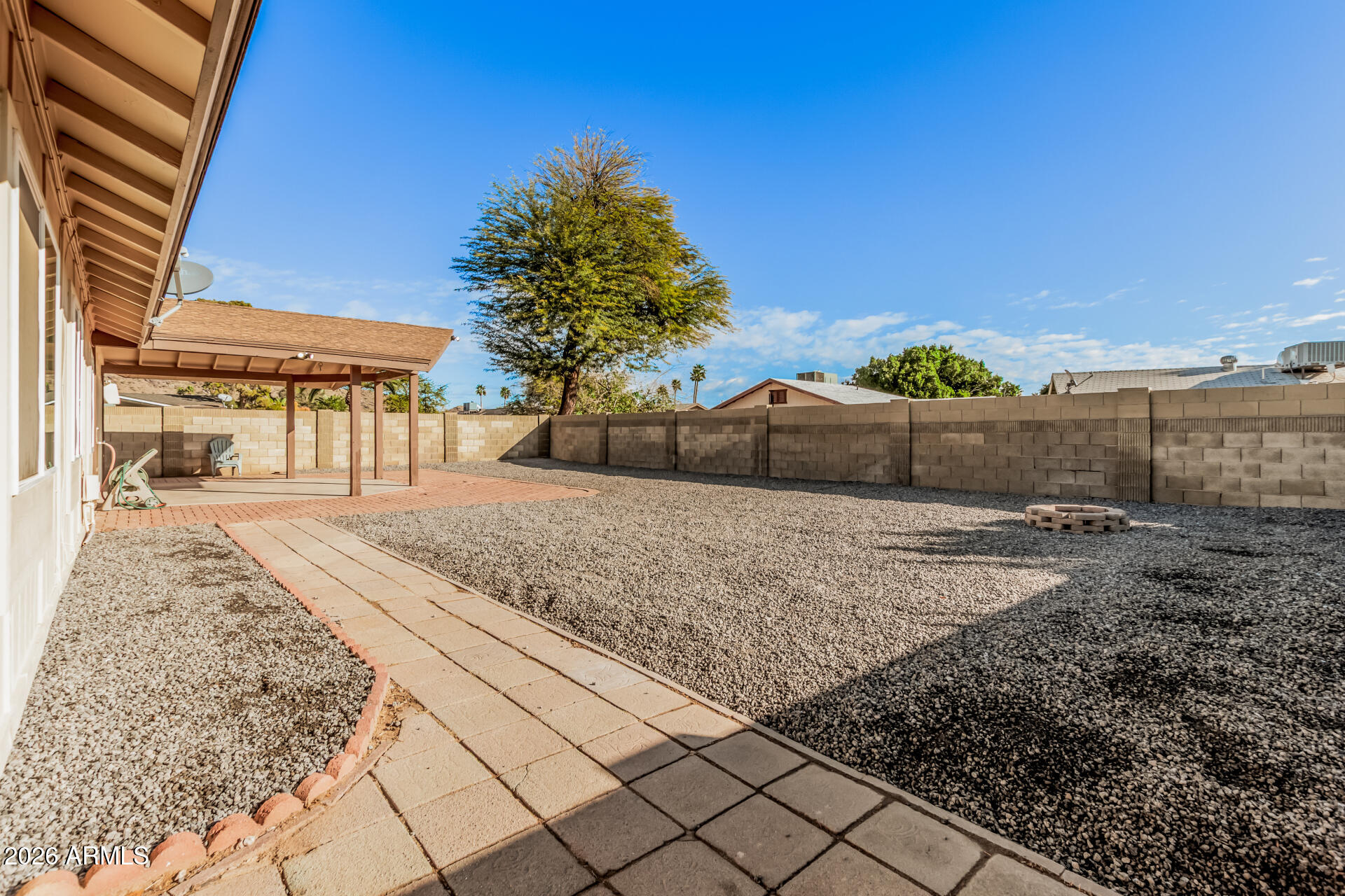 11009 South Tewa Street Phoenix, AZ 85044 - Photo 24 of 26 a view of a dry yard with wooden fence