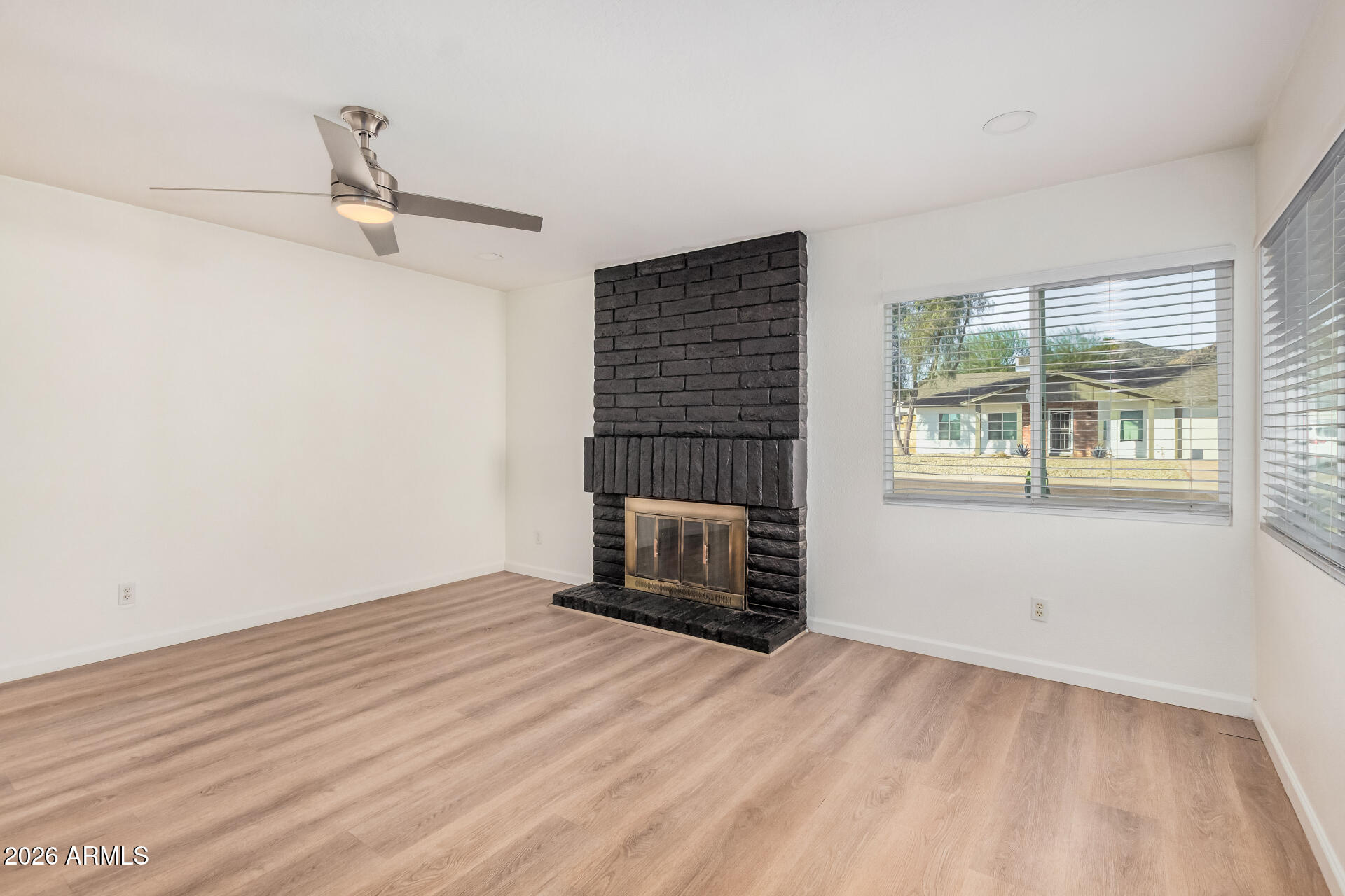 11009 South Tewa Street Phoenix, AZ 85044 - Photo 3 of 26 wooden floor in an empty room with a window