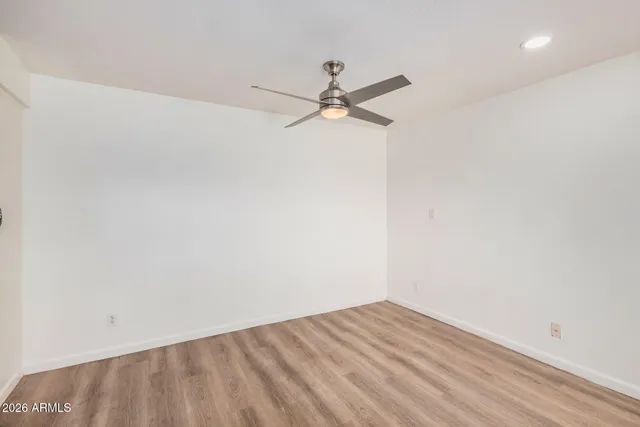 an empty room with a fireplace and windows