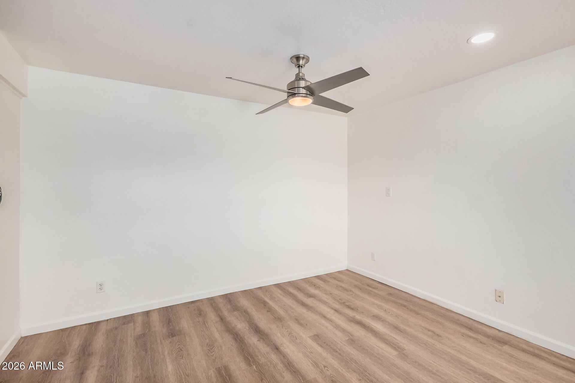 11009 South Tewa Street Phoenix, AZ 85044 - Photo 5 of 26 an empty room with a window and ceiling fan