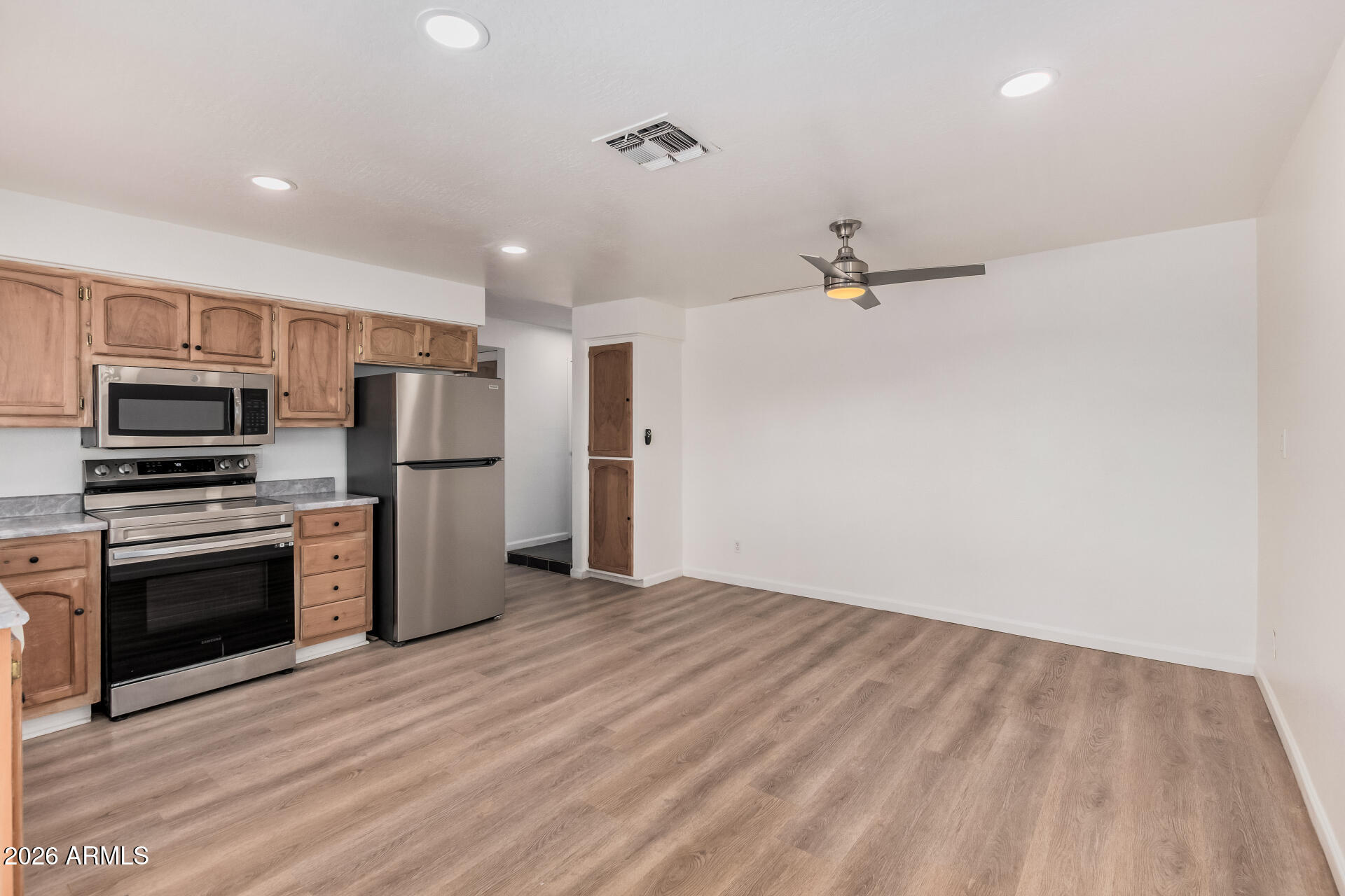 11009 South Tewa Street Phoenix, AZ 85044 - Photo 7 of 26 a view of kitchen with stainless steel appliances wooden floor and large window