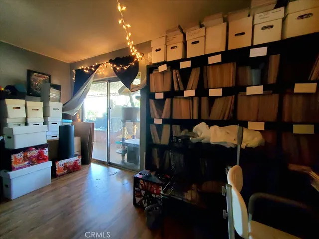 a living room with furniture a flat screen tv and gym equipment