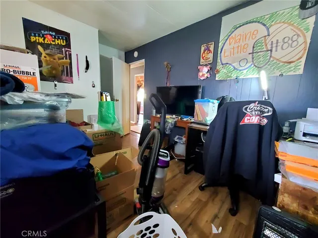 a bedroom with a bed gym equipment and view of living room