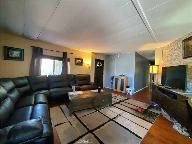 a living room with furniture fireplace and a flat screen tv
