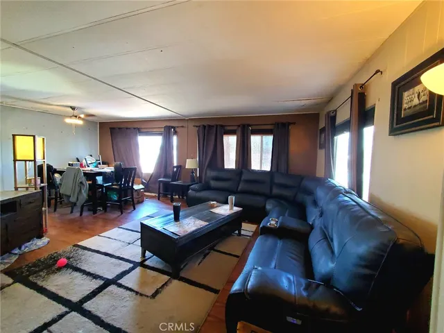 a view of a livingroom with furniture window and wooden floor