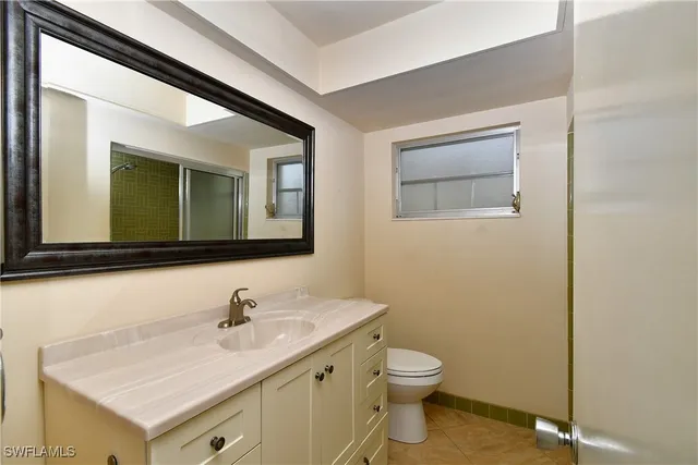 a bathroom with a shower sink vanity and mirror