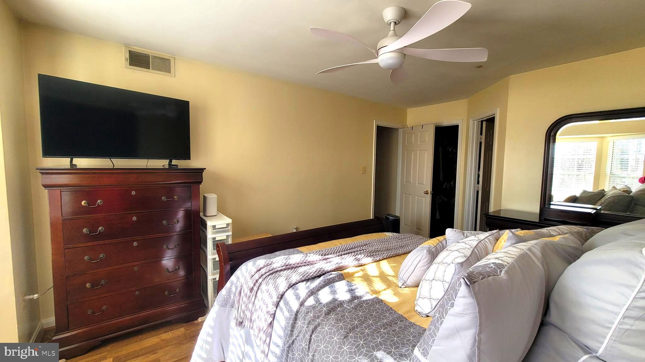 2061 Alice Avenue, Unit 2061303 Oxon Hill, MD 20745 - Photo 11 of 13 a bedroom with a bed and a flat screen tv