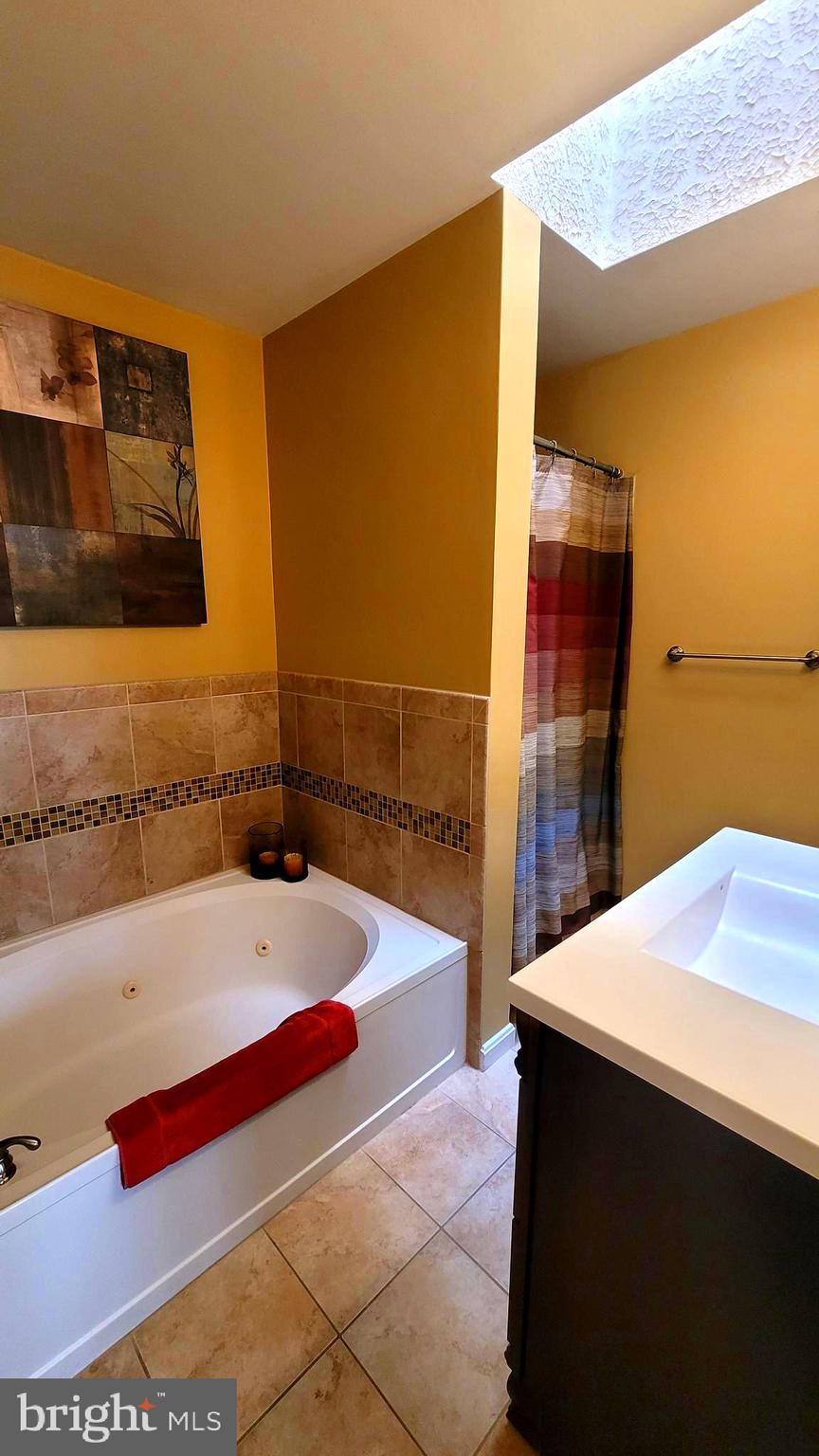 2061 Alice Avenue, Unit 2061303 Oxon Hill, MD 20745 - Photo 12 of 13 a bathroom with a bathtub and a sink