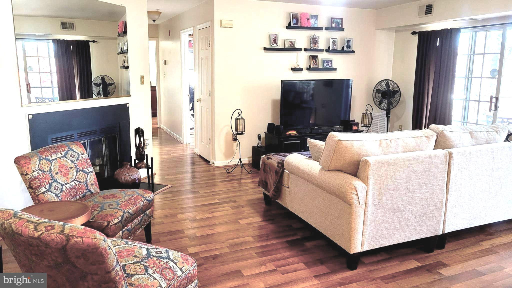 2061 Alice Avenue, Unit 2061303 Oxon Hill, MD 20745 - Photo 2 of 13 a living room with furniture and wooden floor