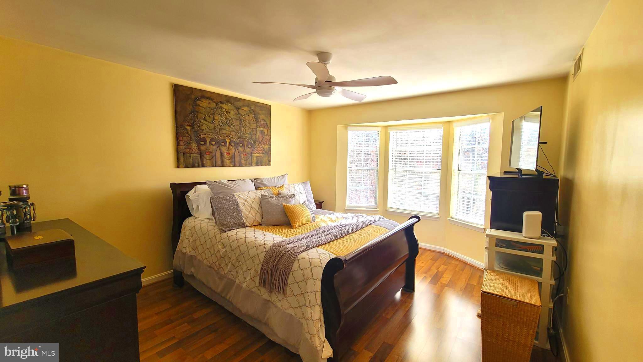 2061 Alice Avenue, Unit 2061303 Oxon Hill, MD 20745 - Photo 5 of 13 a bed room with a bed and a night stand