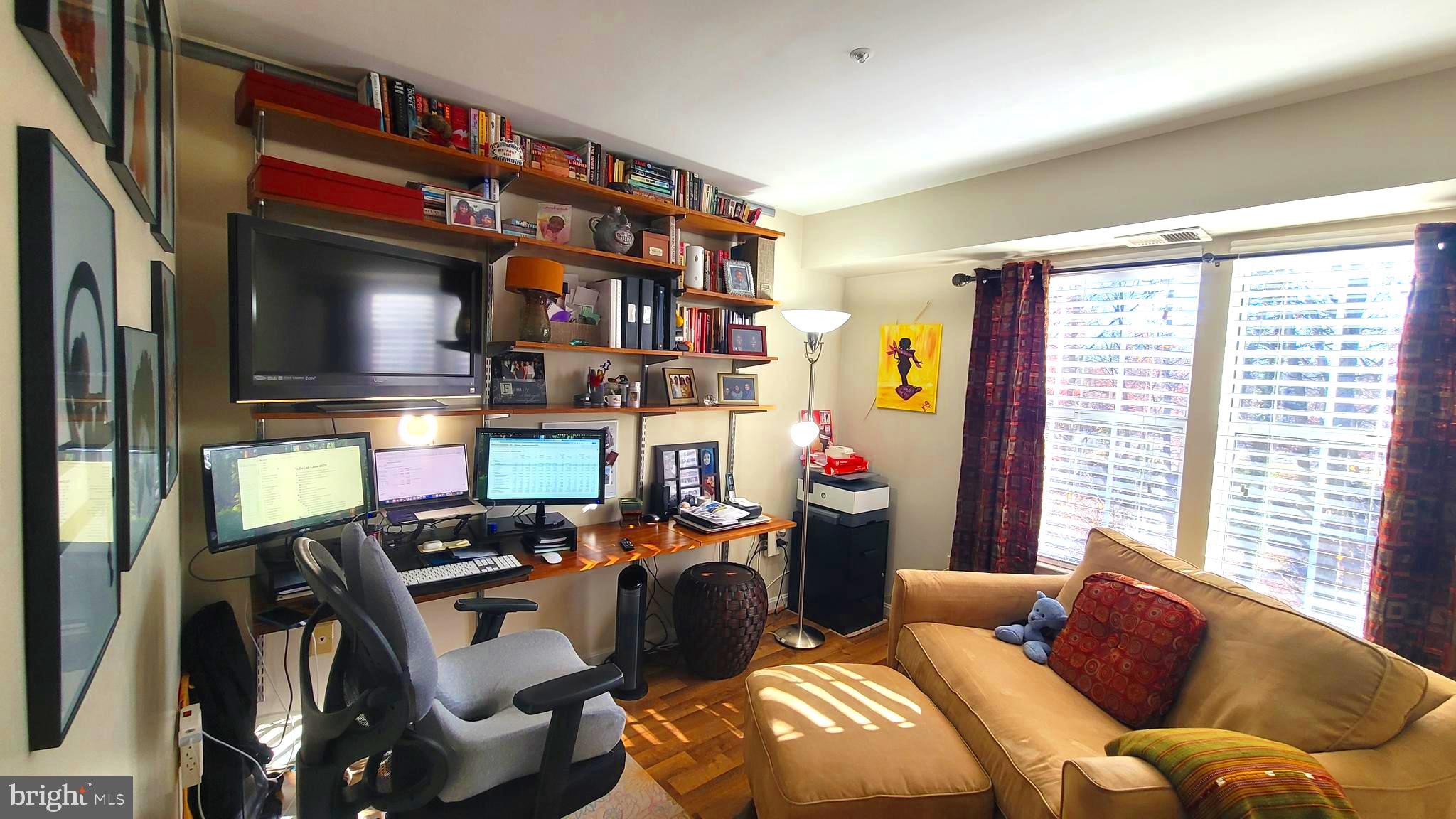 2061 Alice Avenue, Unit 2061303 Oxon Hill, MD 20745 - Photo 8 of 13 a living room with furniture a flat screen tv and a window