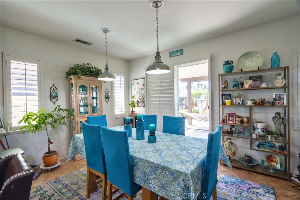 27929 Crystal Spring Drive Menifee, CA 92584 - Photo 11 of 50 a dining room with furniture and wooden floor