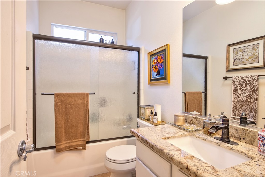 27929 Crystal Spring Drive Menifee, CA 92584 - Photo 17 of 50 a bathroom with a granite countertop sink mirror vanity and toilet