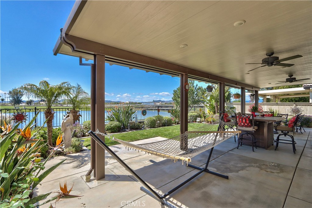 27929 Crystal Spring Drive Menifee, CA 92584 - Photo 27 of 50 a view of a patio with a dining table and chairs