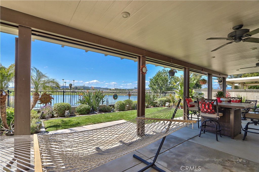 27929 Crystal Spring Drive Menifee, CA 92584 - Photo 30 of 50 a view of a patio with a dining table and chairs