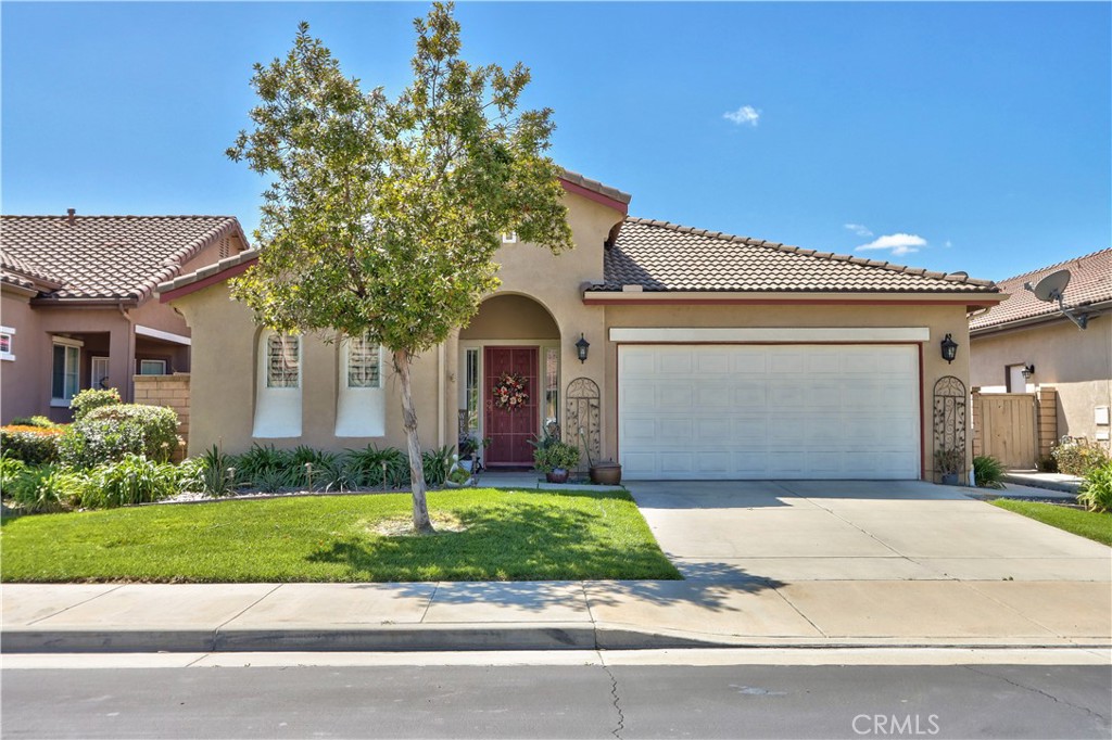 27929 Crystal Spring Drive Menifee, CA 92584 - Photo 4 of 50 a front view of a house with a garden and plants