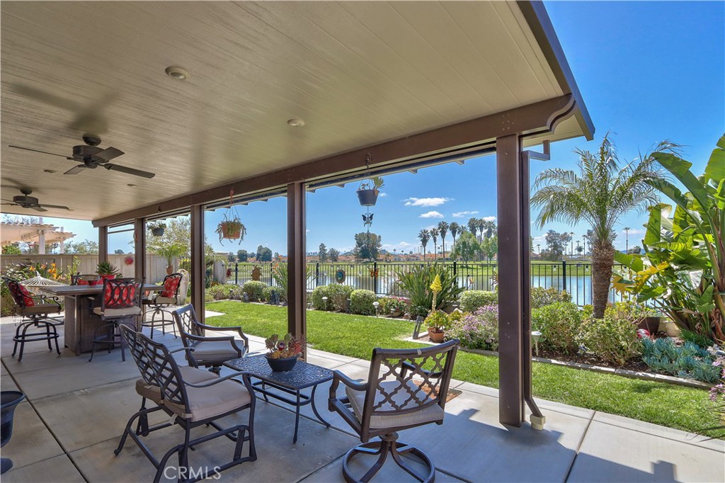 27929 Crystal Spring Drive Menifee, CA 92584 - Photo 6 of 50 a view of a porch with chairs and backyard