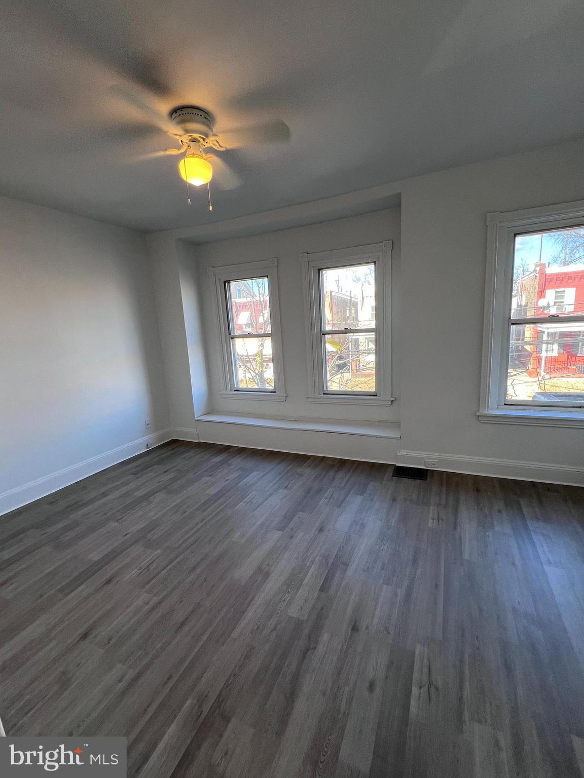 2117 West 4th Street Chester, PA 19013 - Photo 15 of 35 an empty room with wooden floor and windows