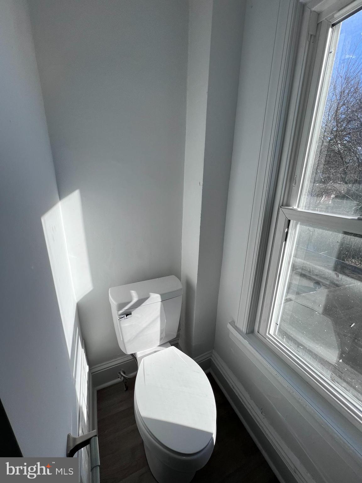 2117 West 4th Street Chester, PA 19013 - Photo 23 of 35 a white toilet sitting next to a window