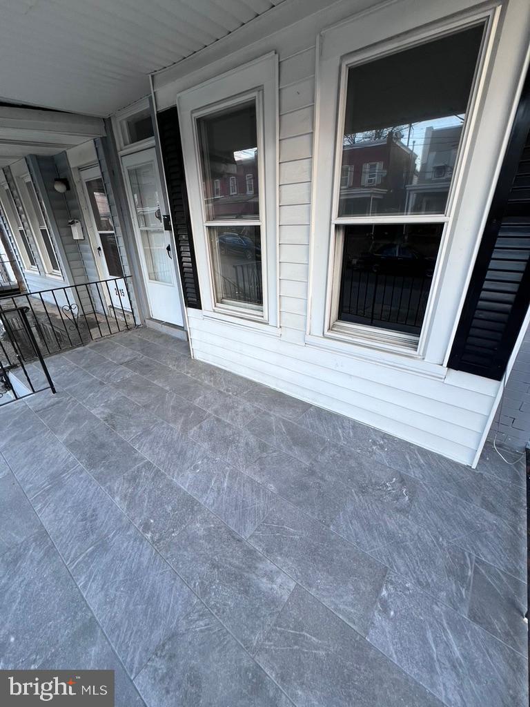 2117 West 4th Street Chester, PA 19013 - Photo 3 of 35 a view of an empty room with wooden floor and windows