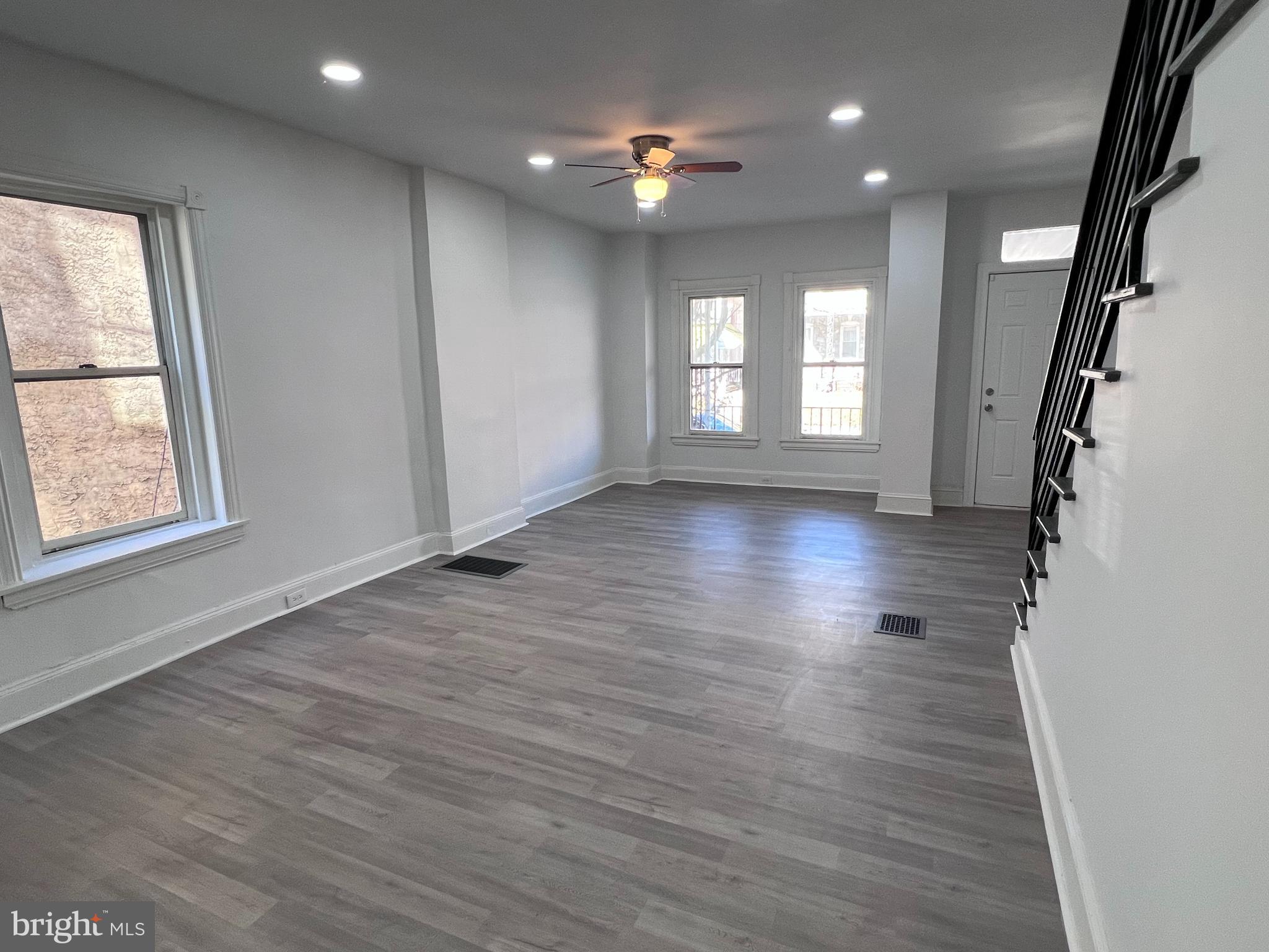 2117 West 4th Street Chester, PA 19013 - Photo 6 of 35 an empty room with wooden floor and windows