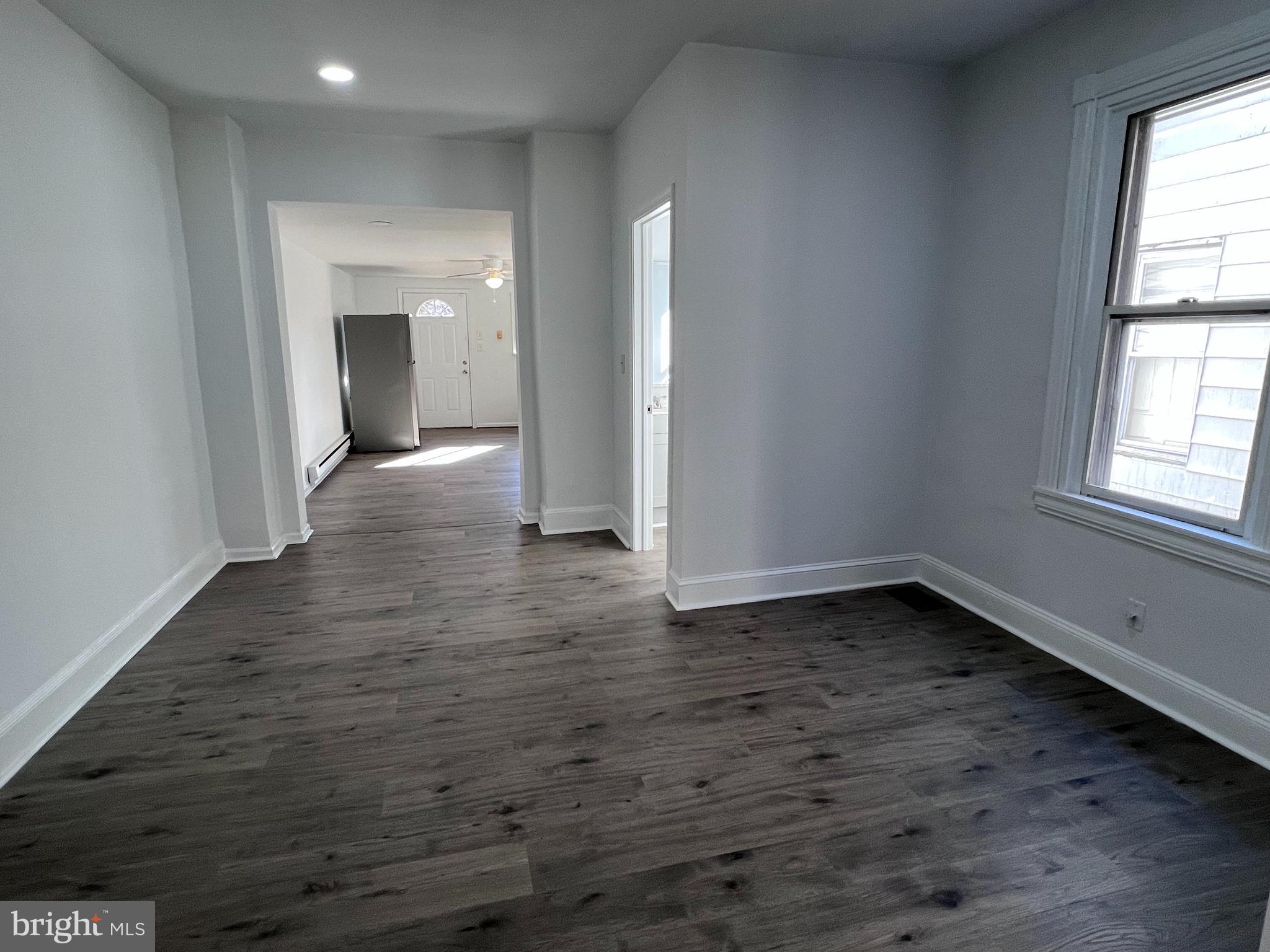 2117 West 4th Street Chester, PA 19013 - Photo 7 of 35 an empty room with wooden floor and windows