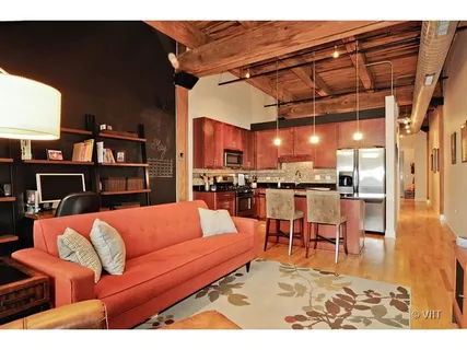 a living room with furniture and kitchen view