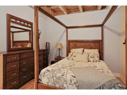 a bedroom with a bed and a dresser